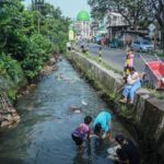 Warga mencuci jeroan hewan kurban di aliran kali kawasan Pitara, Depok, Sabtu (7/6/2025). Aktivitas ini menjadi pemandangan rutin saat momen Idul Adha tiba.