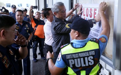 GAME OVER. Interior Secretary Jonvic Remulla (center) and other government officials lead the formal closure of the Island Cove resort-turned Philippine offshore gaming operator facility in Kawit, Cavite on Tuesday (Dec. 17, 2024). The POGO facility, located on a 33-hectare property, is the biggest in the country. (PNA photo by Yancy Lim)