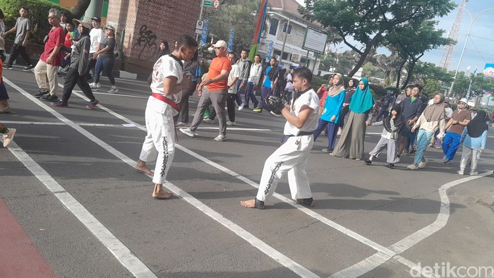 Atlet muda olahraga tarung derajat membuat pengunjung car free day (CFD) Depok berdecak kagum. Keramaian jalan Raya Margonda di kala CFD tidak mengurangi performa latihan para petarung derajat. Foto: Averus Al Akutsar/detikHealth