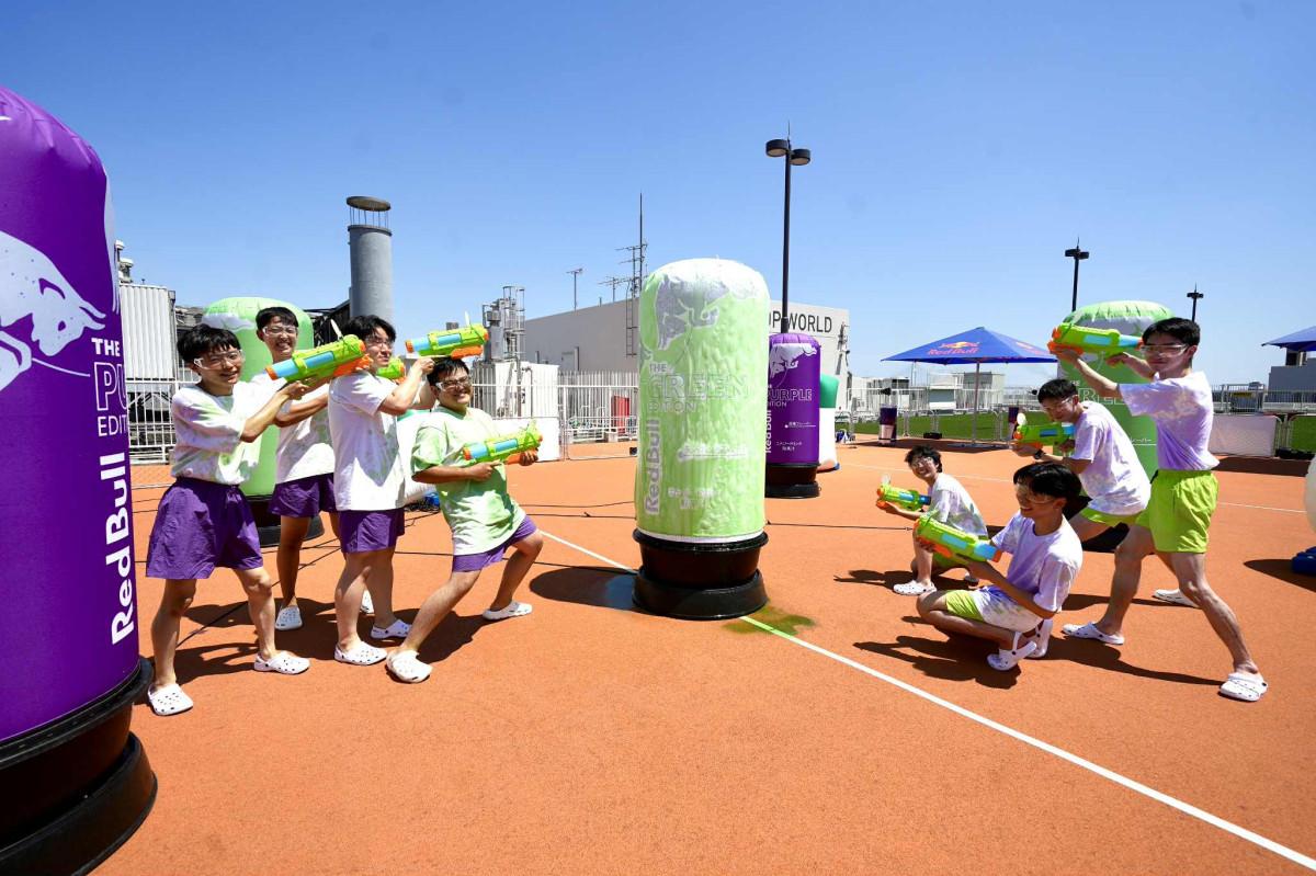 Members of the Kanagawa University Survival Game Club enjoying a game divided into Green and Purple teams