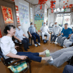 DAY CARE. At Isshoen, a day care facility in Tokorozawa, Saitama Prefecture, serving Japanese war orphans left behind in China, Mariko Kamijo (far left), the eldest daughter of a Japanese war orphan, participates in light exercises with clients on July 2.. (Jiji Press photo)