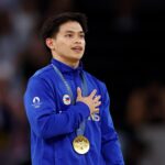 Paris 2024 Olympics - Artistic Gymnastics - Men's Vault Victory Ceremony - August 04, 2024. Gold medalist Carlos Yulo of Philippines celebrates on the podium with his medal. REUTERS/Hannah Mckay