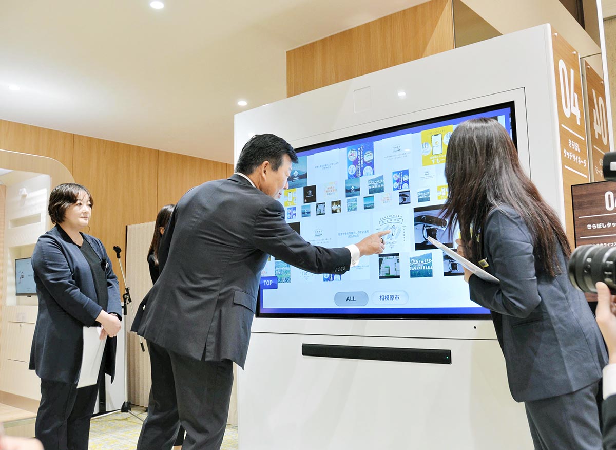 体験型コンテンツを体感する渡辺頭取（中央）＝８日、相模原市中央区