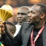 Senegal's head coach Pape Thiaw holds the trophy after winning the Africa Cup of Nations final soccer match agaisnt Morocco, in Rabat, Morocco, Sunday, Jan. 18, 2026. (AP Photo/Mosa'ab Elshamy)