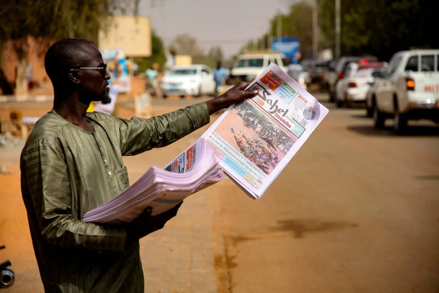 A newspaper vendor on a street in Niamey following the attack on the international airport in the capital