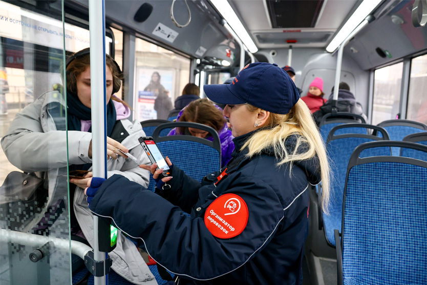 Checking fare payment inside a vehicle.