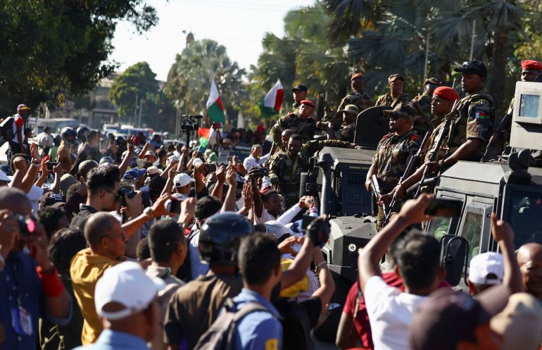 Members of the military look on as they leave after joining protesters gathered outside the town hall on Independence Avenue during a nationwide youth-led demonstration against frequent power outages and water shortages, in Antananarivo, Madagascar, October 14, 2025.