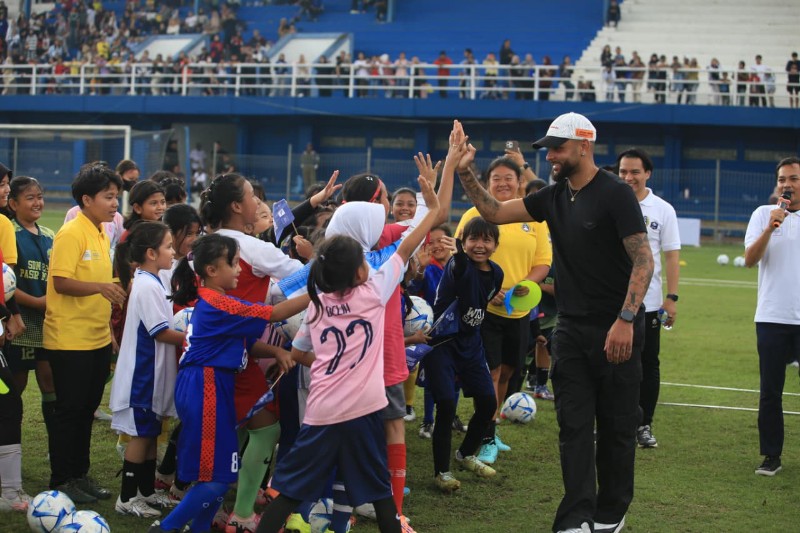 Pemain Persib Bandung Layvin Kurzawa menyapa peserta coaching clinic untuk pesepakbola putri u8, u10, u12 di stadion Persib.