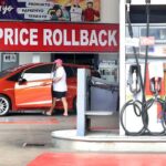 Motorists pass by a "price rollback" banner at a gasoline station along Katipunan Avenue in Quezon City on April 14, 2026 following weeks of relentless price hikes. Fuel companies implemented price rollbacks with diesel by P20.89 per liter, gasoline by P4.43 per liter and kerosene by P8.50 per liter.