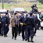 On April 15, 2026, police officers head toward the home of 11-year-old Yuki Adachi, who was found dead, in Nantan, Kyoto Prefecture. (Mainichi/Rintaro Nagasawa)