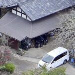 This photo taken from a Kyodo News helicopter shows police investigators searching the house of a missing 11-year-old boy found dead alongside a road in a wooded area in Kyoto Prefecture, on April 15, 2026. (Kyodo)