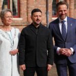 The The King's Commissioner of Zeeland Hugo de Jonge, right, and the Mayor of Middleburg Yvonne van Mastrigt, left, welcome Ukraine's President Volodymyr Zelenskyy for the International Four Freedoms Award ceremony in Middelburg, Netherlands, April 16, 2026. (AP Photo/Peter Dejong)