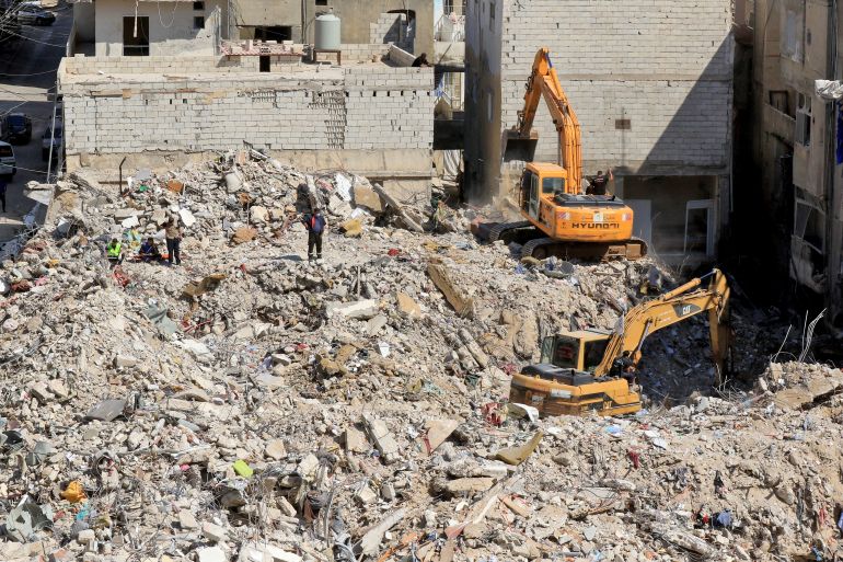Diggers remove the rubble of buildings destroyed in Israeli strikes as they look for survivors buried underneath in the southern Lebanese coastal city of Tyre on April 21, 2026.