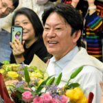 練馬区長選の当選を決め、支持者らと笑顔で写真撮影する吉田健一氏=2026年4月12日午後11時43分、東京都練馬区、木佐貫将司撮影
