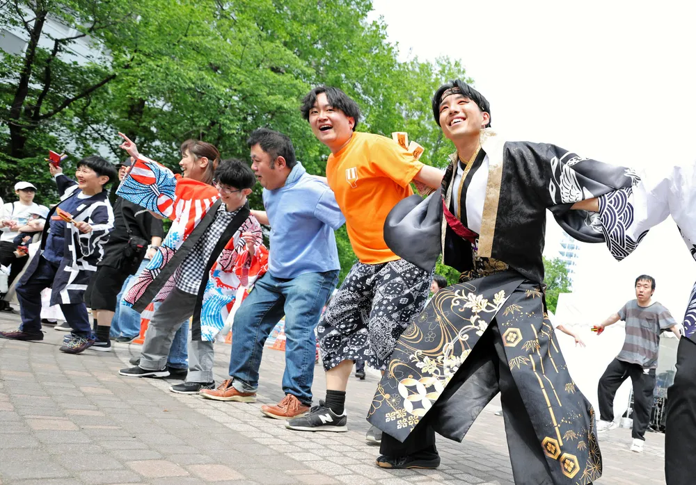 昨年のワオドリスクエアで一緒に踊るヨサコイチームの踊り手と飛び入り参加した市民ら