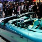 People gather next to the newly presented Z Convertible EV of BYD's luxury brand Denza at the company’s booth at the Beijing International Automotive Exhibition (Auto China), in Beijing, China, April 24, 2026. REUTERS/Maxim Shemetov