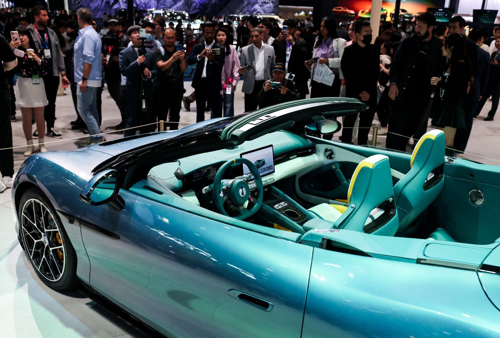 People gather next to the newly presented Z Convertible EV of BYD's luxury brand Denza at the company’s booth at the Beijing International Automotive Exhibition (Auto China), in Beijing, China, April 24, 2026. REUTERS/Maxim Shemetov