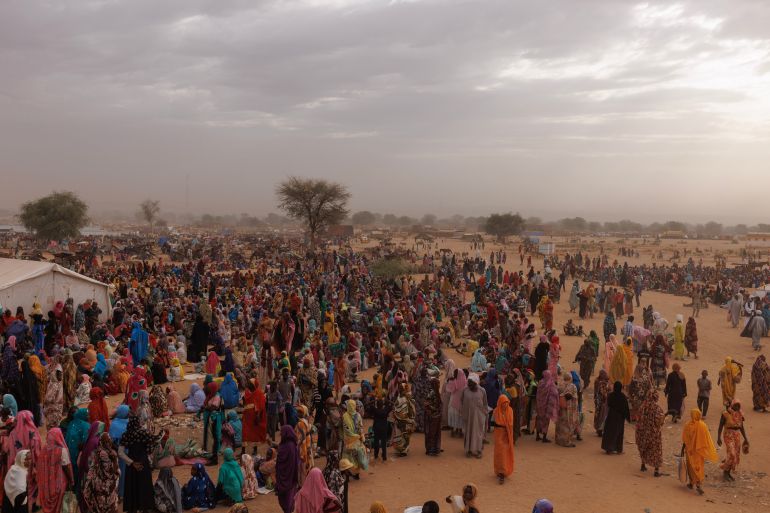 ADRE, CHAD - APRIL 22: Refugees, mostly women and children wait for a WFP food distribution point to open at a temporary camp on April 22, 2024 in Adre, Chad. Since the beginning of the recent conflict between the paramilitary Rapid Support Forces (RSF) and the the Sudanese Armed Forces, (SAF), which began in March 2023, over 600,000 new refugees have crossed the border from Darfur in Sudan, into Chad. The total number of refugees, including those from previous conflicts, now stands at 1.2 million. Aid agencies, including The World Food Programme, (WFP), Médecins Sans Frontières (MSF) and the United Nations High Commissioner for Refugees, (UNHCR), already struggling with accute supply shortages, have warned that the life-saving programmes in Chad, will ‘grind to a halt in a matter of weeks without urgent funding’. Chad is now home to one of the largest and fastest-growing refugee populations in Africa. (Photo by Dan Kitwood/Getty Images)