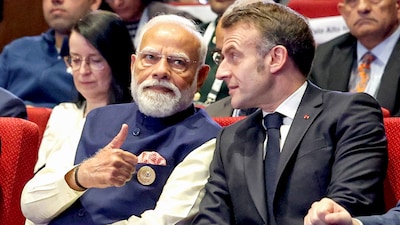 Prime Minister Narendra Modi talks to France President Emmanuel Macron (PTI)