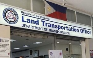 Sign for the Land Transportation Office, Department of Transportation, Republic of the Philippines, with a Philippine flag above.
