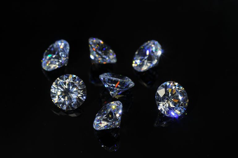 Round diamond faceted cubic zirconia set lot, cubic crystalline form of zirconium dioxide (ZrO2) colorless synthesized material. White synthetic gemstones. Diamond imitation. Black isolated background; Shutterstock ID 1992356717; purchase_order: ajanet; job: ; client: ; other: