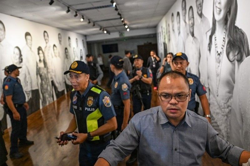 Police personnel guide the media after the exchange of gunshots inside the Senate of the Philippines in Pasay, Metro Manila on May 13, 2026.