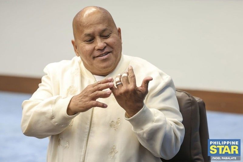 Sen. Ronald "Bato" Dela Rosa shows his bandaged fingers to reporters before the Senate plenary session on May 12, 2026, a day after National Bureau of Investigation agents pursued him through the building to serve an arrest warrant.