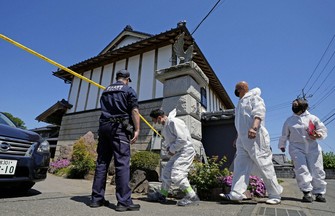 Investigators enter the scene of a robbery-murder case in Kaminokawa, Tochigi Prefecture, north of Tokyo, on May 17, 2026. (Kyodo)