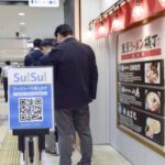 A notice for the SuiSui service is displayed at Tokyo Ramen Yokocho in Tokyo on April 27, 2026. (Kyodo)