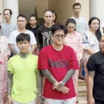 Rapper Mr. Nhân (áo đỏ) bị khởi tố, tạm giam - Ảnh: Công an TP.HCM