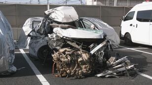 Car severely damaged... Head-on collision with a truck; man in his 20s driving the passenger car dies - Road with one lane each side; one vehicle may have crossed the center line - Miyoshi City, Aichi