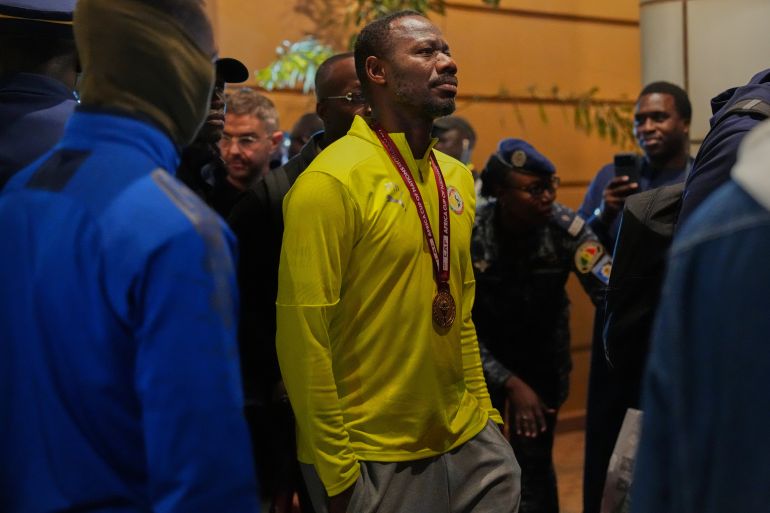 Senegal's head coach Pape Thiaw arrives at the airport following his side's victory in the Africa Cup of Nations soccer tournament in Ndiass, Senegal, early Tuesday, Jan. 20, 2026.