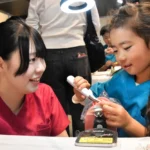 専用のブラシを使って歯の模型の汚れを落とす子ども
