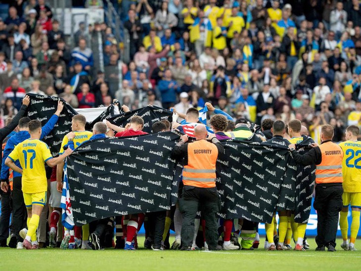 Cầu thủ Đan Mạch và Ukraine quây thành vòng tròn để bảo vệ cho Eriksen sau khi anh đổ gục - Ảnh: AFP