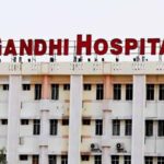 Gandhi Hospital building with prominent red signage in Hyderabad, India, serving as a major healthcare fa.