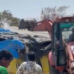 A JCB in action during an anti-encroachment drive